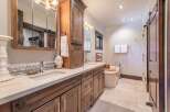 This luxurious bathroom features a stunning vanity with dual sinks, ample storage, and a beautiful countertop.