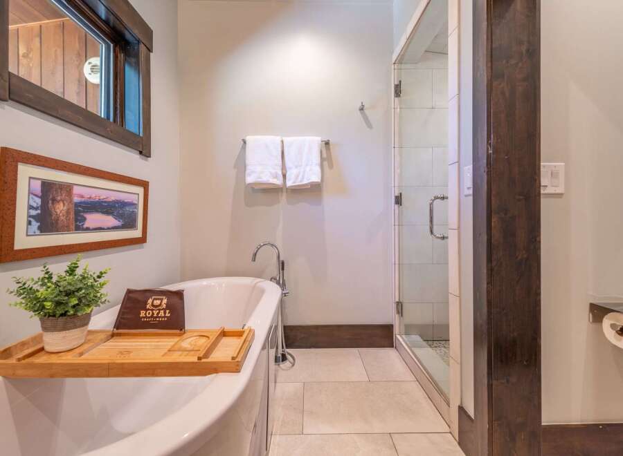 Indulge in the luxury of this beautifully designed bathroom, featuring a freestanding tub and a separate glass-enclosed shower.