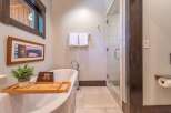 Indulge in the luxury of this beautifully designed bathroom, featuring a freestanding tub and a separate glass-enclosed shower.