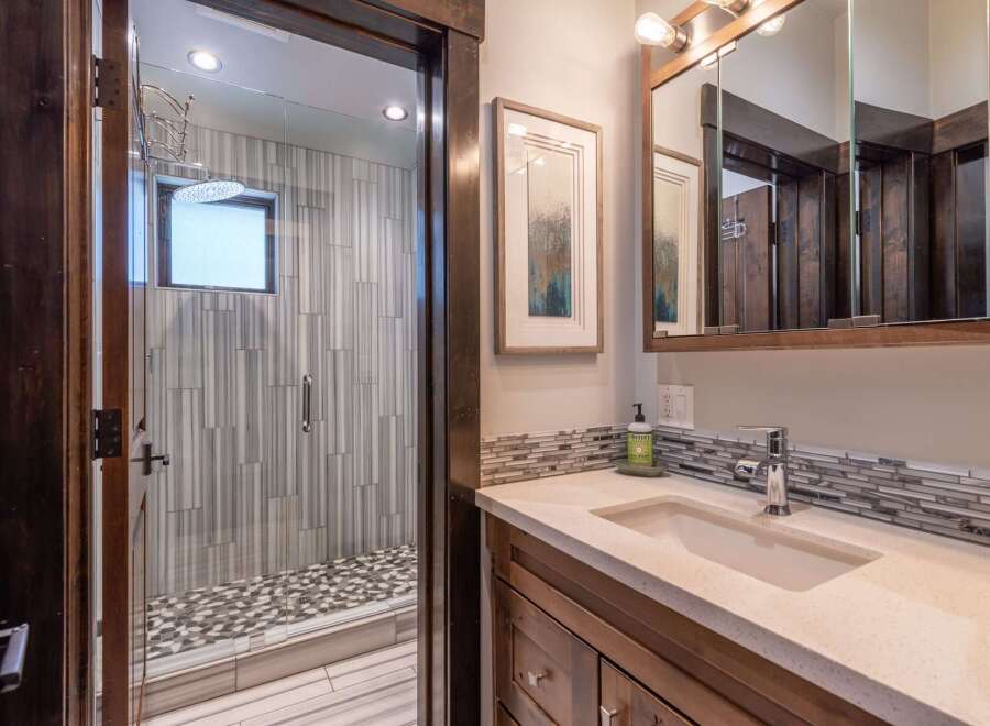 Step into luxury with this stunning bathroom featuring a modern shower with elegant tile work.