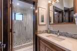 Step into luxury with this stunning bathroom featuring a modern shower with elegant tile work.
