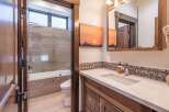 Step into this beautifully designed bathroom, featuring a modern vanity and a stunning sunset-themed artwork.