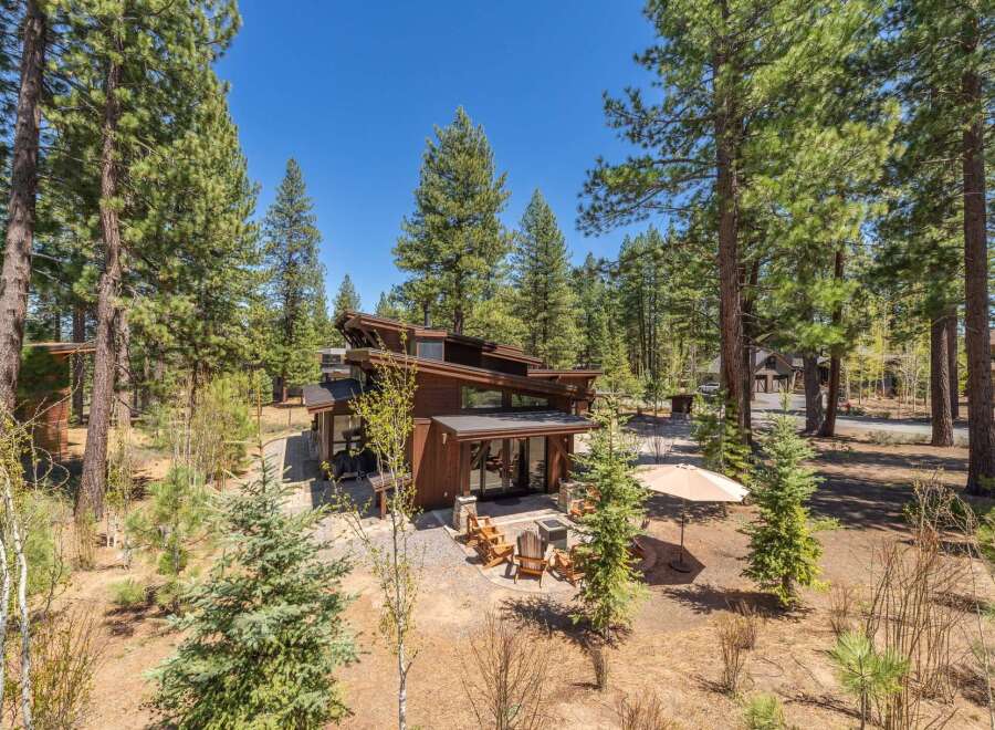 Nestled amidst towering pines, this stunning modern home offers a serene escape.