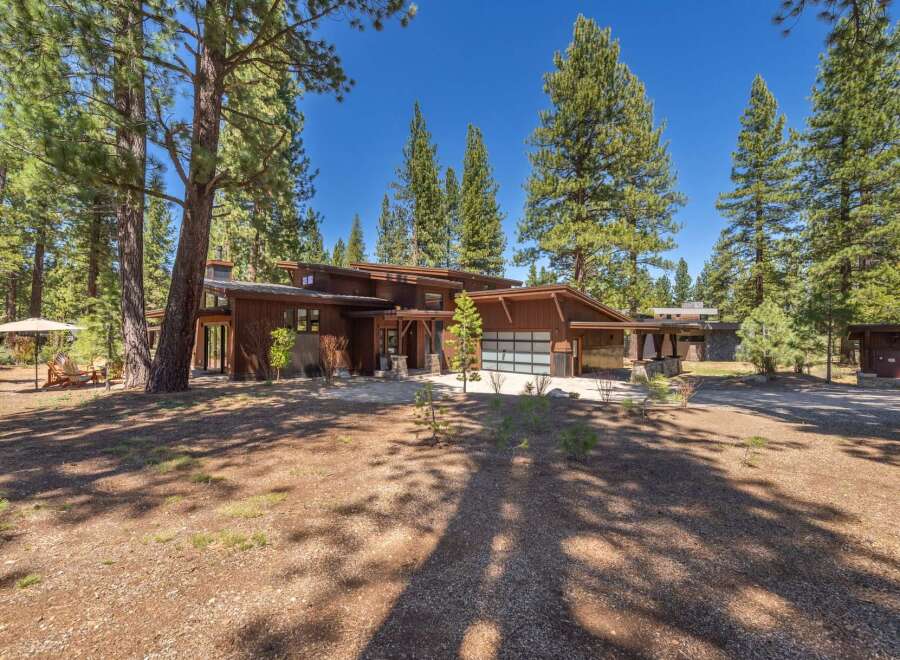 This stunning property boasts a modern architectural design with a warm, inviting aesthetic.