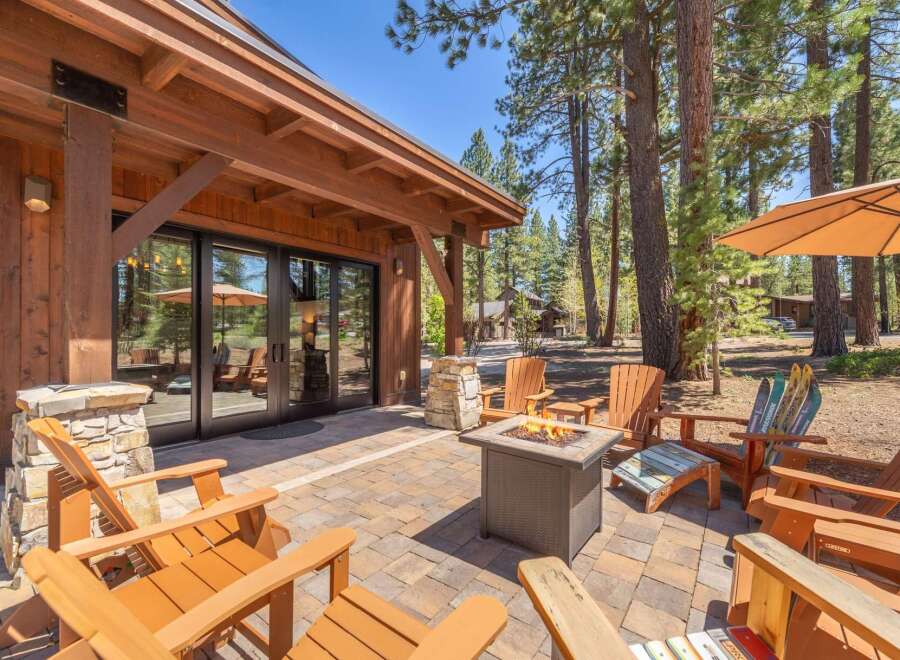 Enjoy the ultimate outdoor living experience with this stunning property! Featuring a cozy fire pit, comfortable Adirondack chairs, and a beautiful patio, this space is perfect for entertaining or relaxing.