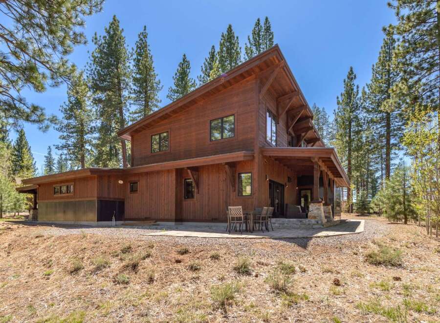 Nestled amidst towering trees, this stunning wooden home offers a serene retreat.