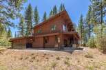 Nestled amidst towering trees, this stunning wooden home offers a serene retreat.