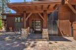 This stunning property boasts a beautiful wooden exterior and a welcoming entrance.