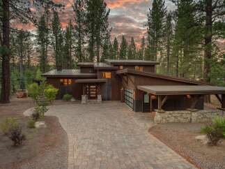 Experience modern mountain living in this stunning custom-built home nestled among tall pines.