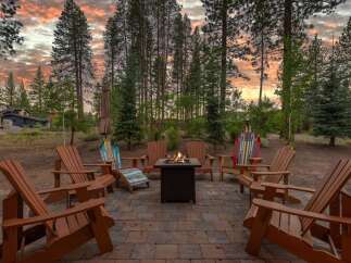 Experience the ultimate outdoor living with this stunning patio featuring a cozy fire pit, perfect for gathering with loved ones.