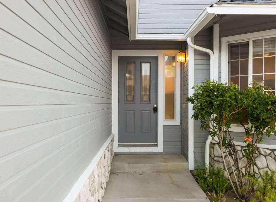 Welcome home to this charming property! Featuring a stylish gray front door and siding, this home offers great curb appeal.