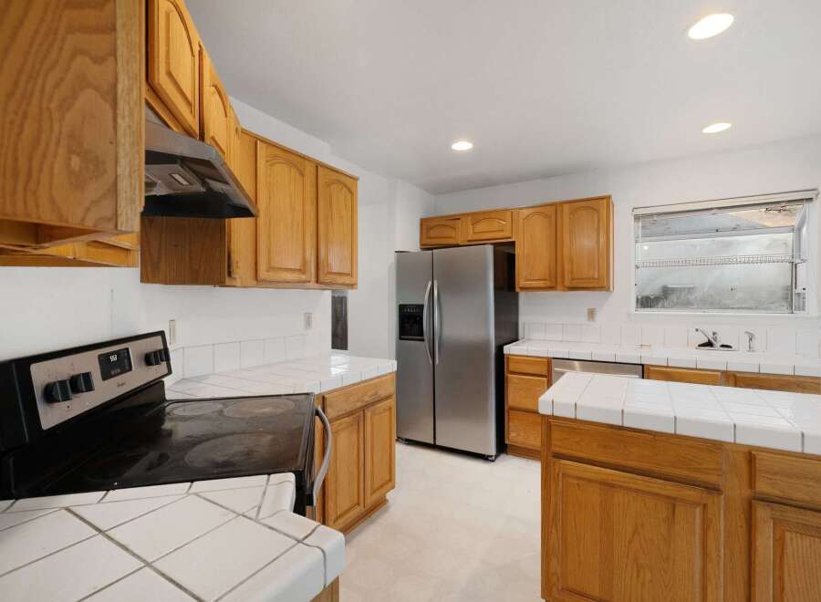 Step into this inviting kitchen, featuring beautiful wooden cabinetry that offers ample storage.