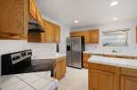 Step into this inviting kitchen, featuring beautiful wooden cabinetry that offers ample storage.