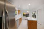 Step into this bright and inviting kitchen, featuring stainless steel appliances and ample cabinet space.