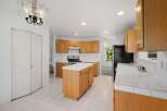 Step into this inviting kitchen, featuring warm wooden cabinetry and ample counter space.