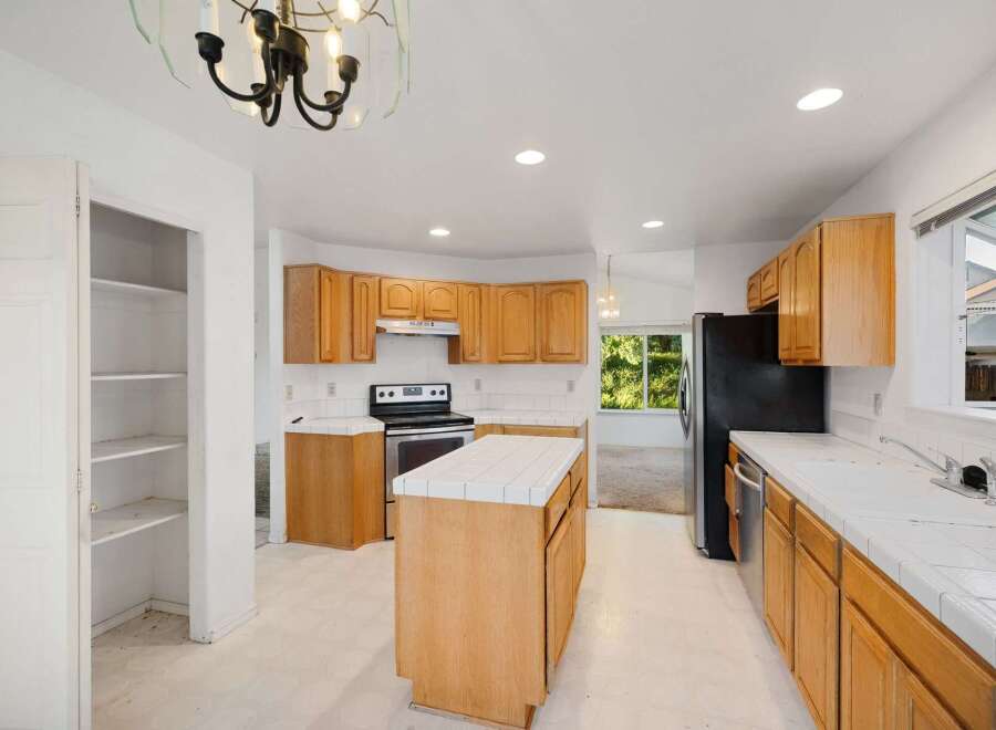 This spacious kitchen features ample cabinet space, perfect for storage and organization.