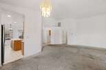 Step into this inviting home featuring a spacious living area with a neutral color palette and plush carpeting.