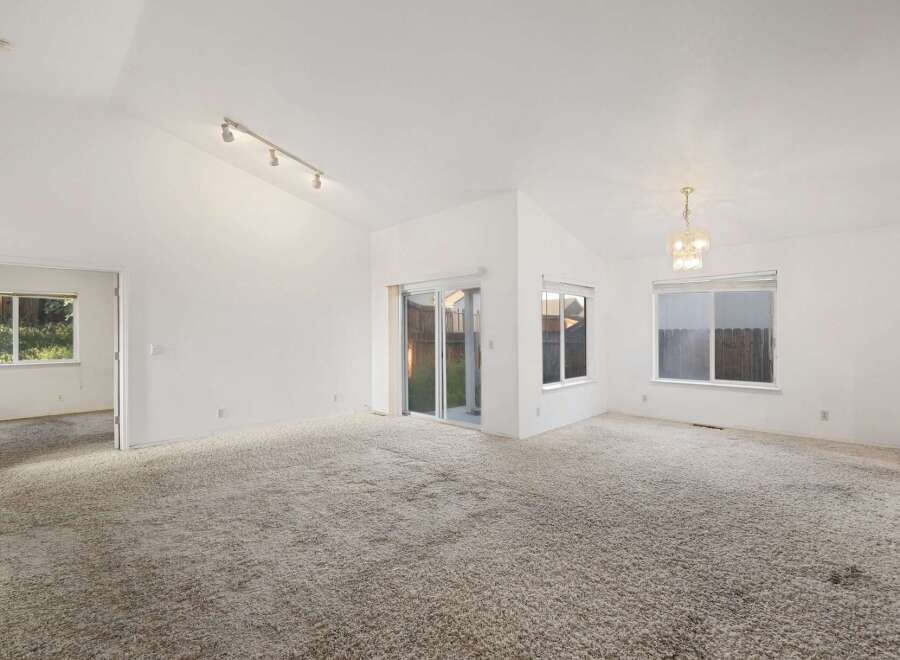 Discover the potential of this spacious property! Featuring a bright and airy interior with high ceilings, this home offers a blank canvas for your personal touch.