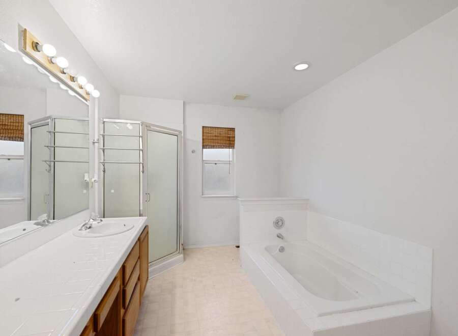 Step into this bright and airy bathroom featuring a spacious layout and modern amenities.