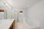 Step into this bright and airy bathroom featuring a spacious layout and modern amenities.