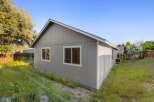 This charming property boasts a well-maintained exterior with a fresh coat of gray paint and crisp white trim.