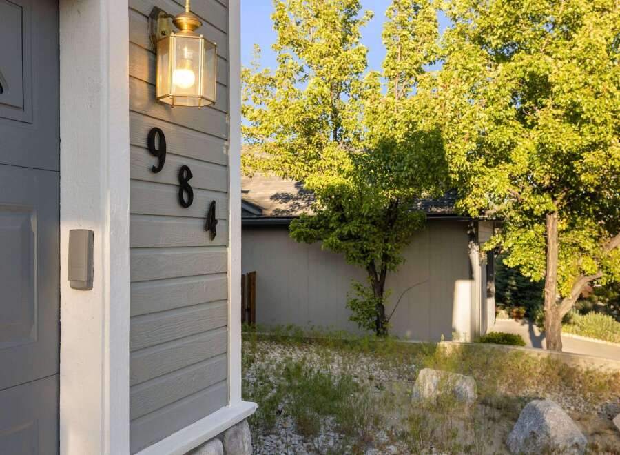 Discover the charm of this inviting property! Featuring a beautifully lit exterior with the address numbers clearly displayed.