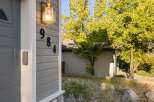 Discover the charm of this inviting property! Featuring a beautifully lit exterior with the address numbers clearly displayed.