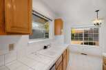 This kitchen features classic wooden cabinetry and a bright, airy feel.