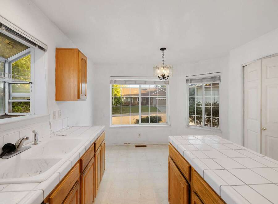 This bright and airy kitchen features a classic design with ample counter space and cabinetry.