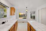 This bright and airy kitchen features a classic design with ample counter space and cabinetry.