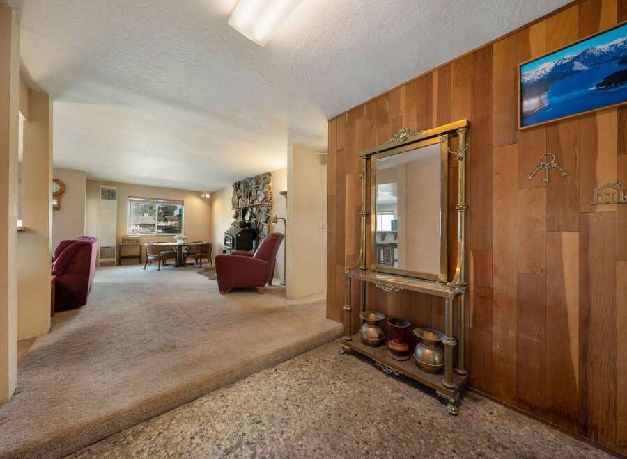 Step into this inviting home featuring a cozy living space with a fireplace and a dining area.