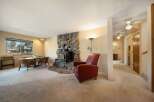 Cozy up in this charming living space featuring a stunning stone fireplace, perfect for those chilly evenings.