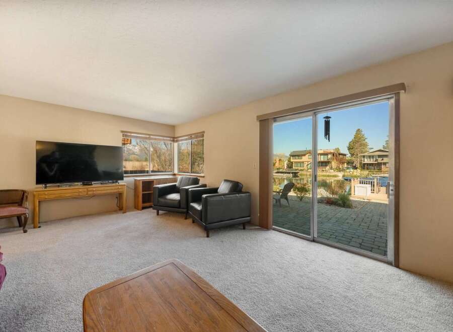 Enjoy stunning waterfront views from this inviting living room.