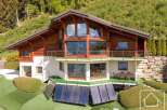 Discover a stunning chalet nestled in a picturesque mountain setting.