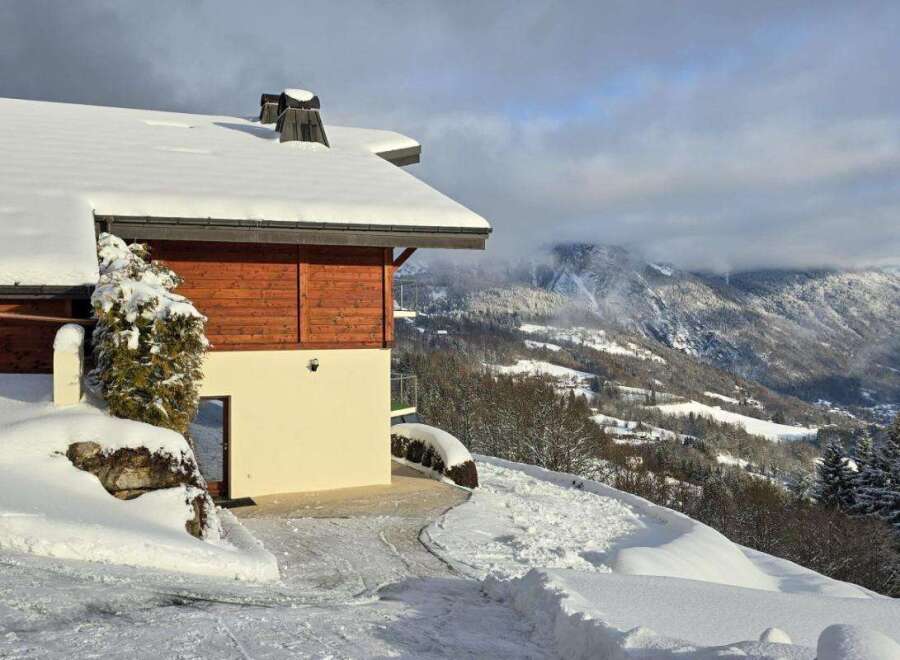 Discover a stunning property nestled in a winter wonderland, offering breathtaking mountain views.