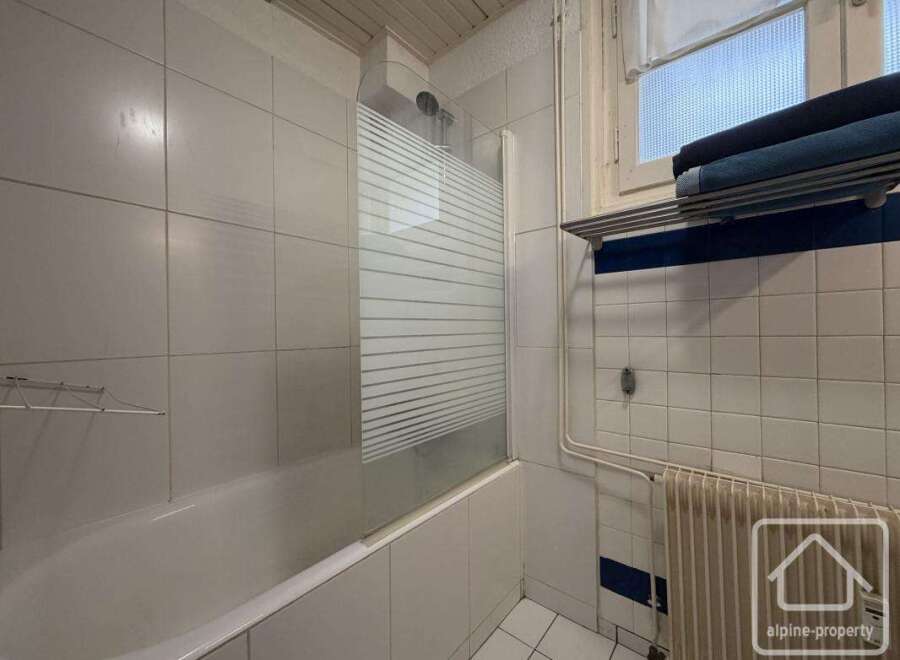 Discover this charming bathroom featuring a bathtub and a convenient shower area.