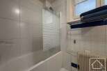 Discover this charming bathroom featuring a bathtub and a convenient shower area.