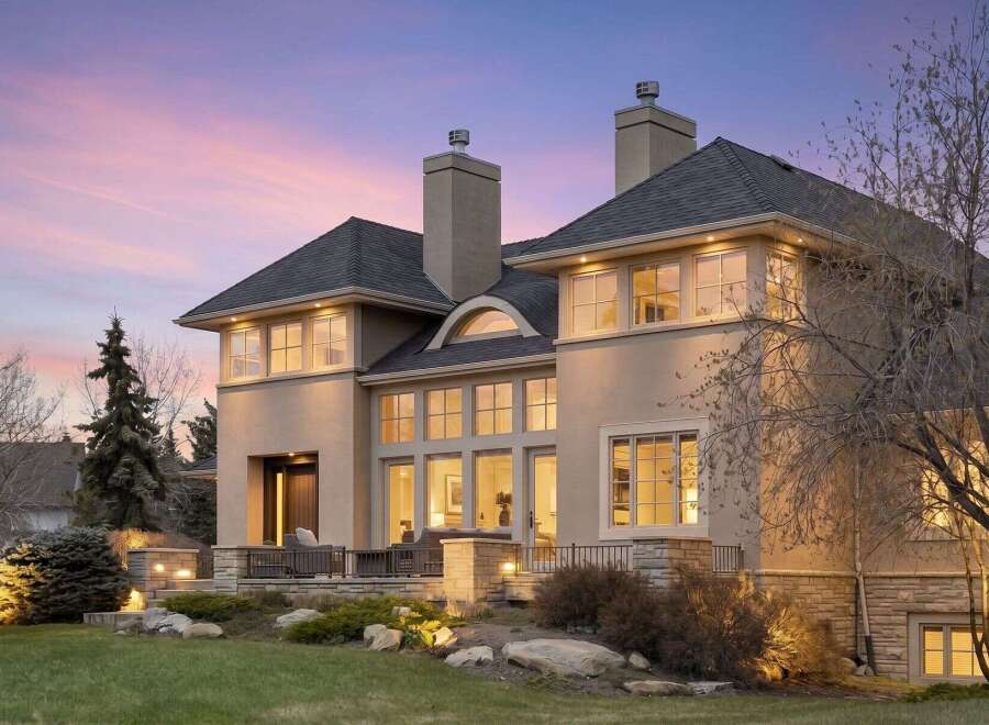 This stunning property showcases a luxurious exterior with a blend of modern and classic design elements.