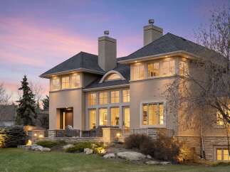 This stunning property showcases a luxurious exterior with a blend of modern and classic design elements.