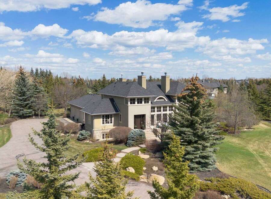 This stunning estate boasts a grand facade and meticulously landscaped grounds, offering a luxurious living experience.
