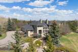 This stunning estate boasts a grand facade and meticulously landscaped grounds, offering a luxurious living experience.