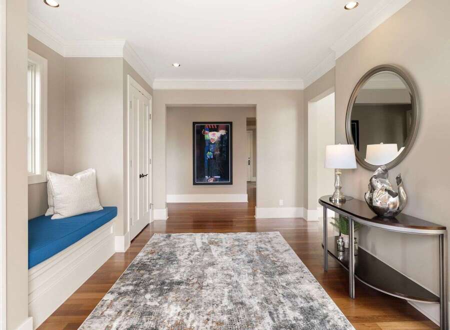 Step into this stunning entryway, showcasing a blend of modern design and inviting warmth.
