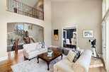 This stunning property boasts a grand entrance with a sweeping staircase and a spacious living area.