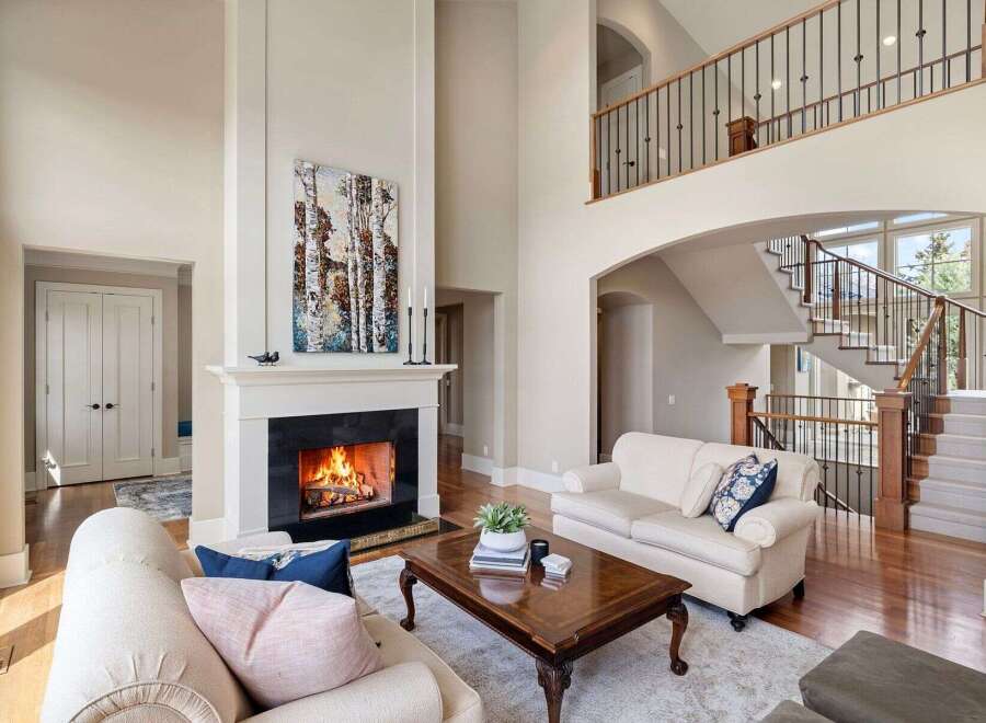 Experience luxury living in this stunning home featuring a cozy fireplace and a grand staircase.