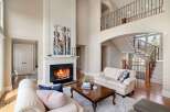 Experience luxury living in this stunning home featuring a cozy fireplace and a grand staircase.