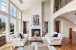 Experience luxury living in this stunning property featuring a grand fireplace, soaring ceilings, and an abundance of natural light.