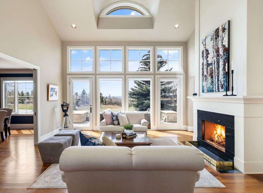 Experience luxury living in this stunning property featuring a spacious living room with expansive windows that offer breathtaking views.