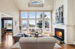 Experience luxury living in this stunning property featuring a spacious living room with expansive windows that offer breathtaking views.