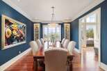 Step into luxury with this stunning dining room, featuring a large wooden dining table and elegant chairs, perfect for hosting gatherings.