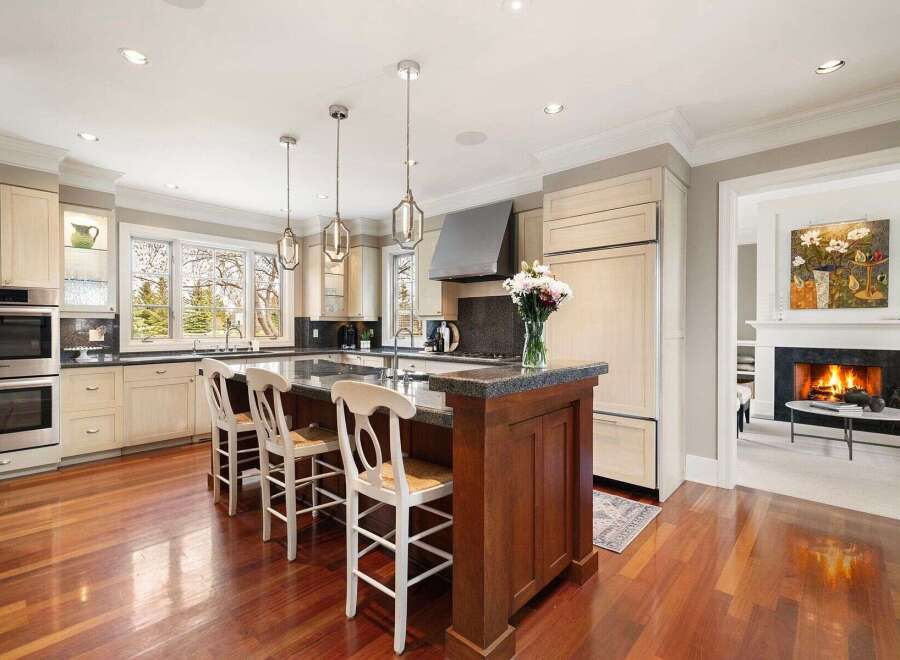 This stunning kitchen boasts a spacious island with seating, perfect for entertaining or casual dining.